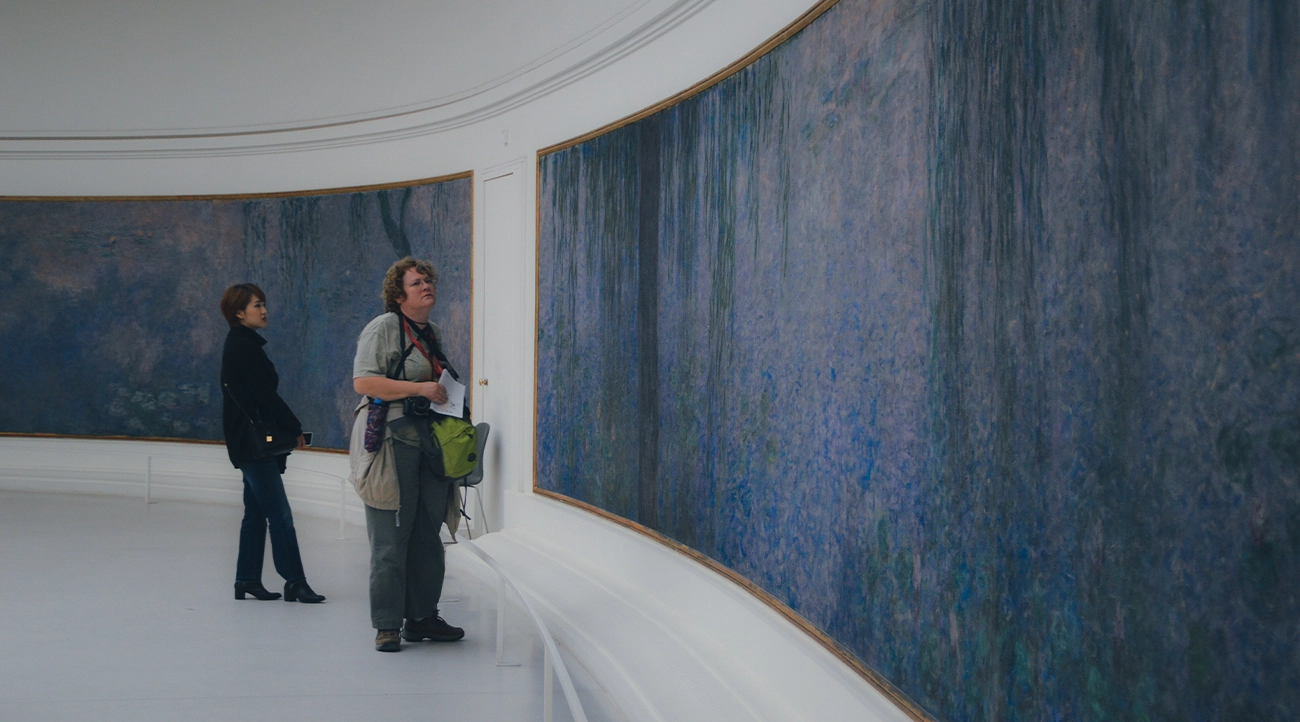 Tourist looking at a Monet painting at the Orangerie
