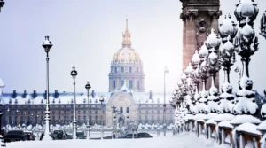 Alexandre III Bridge and Les Invalides covered in snow in winter