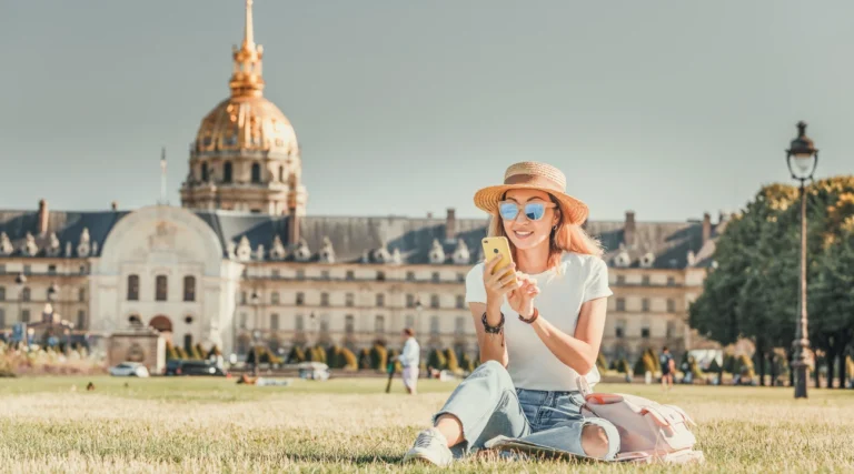 A tourist fiddles with his phone near Les Invalides