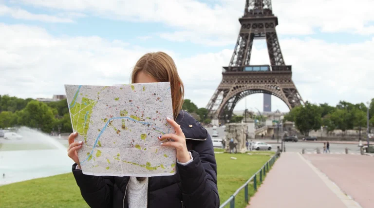 A woman consults a map of Paris because she is lost
